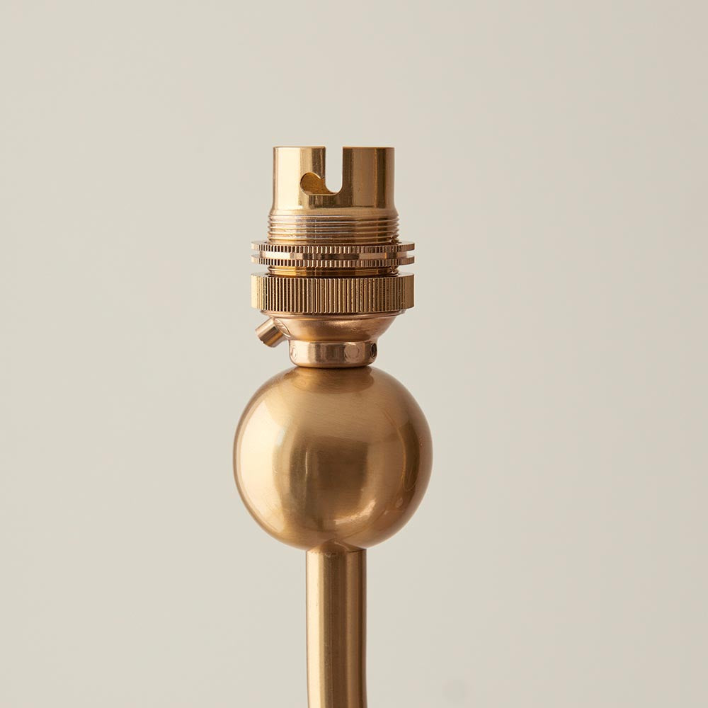 Close-up of the Cliffleigh Leaf pendant's brass lamp holder and threaded fitting above a round brass ball detail, set against a plain light background.