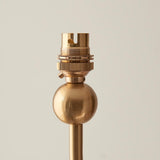 Close-up of the Cliffleigh Leaf pendant's brass lamp holder and threaded fitting above a round brass ball detail, set against a plain light background.