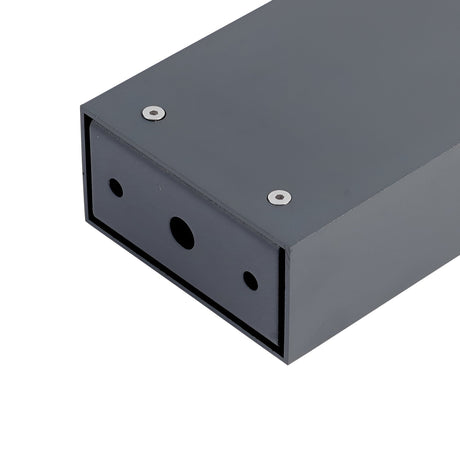 A close-up view of an anthracite rectangular metal box with two screw holes on its surface and a larger circular opening on one end. The design seems perfect for mounting or housing electronic components, making it suitable as part of outdoor lighting such as the Luma Outdoor Bollard Light - Anthracite, 80cm.