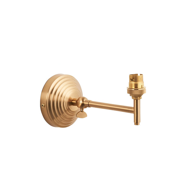 Endon Casthurst wall light with stepped round back plate, adjustable knuckle, linear arm and B22 lampholder in brushed aged brass on a white background.