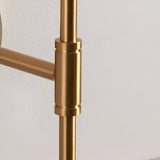 Close-up of the Endon Brackfield Wall Light showing the brushed aged brass T-bar arm joint and upright stem against a white wall.