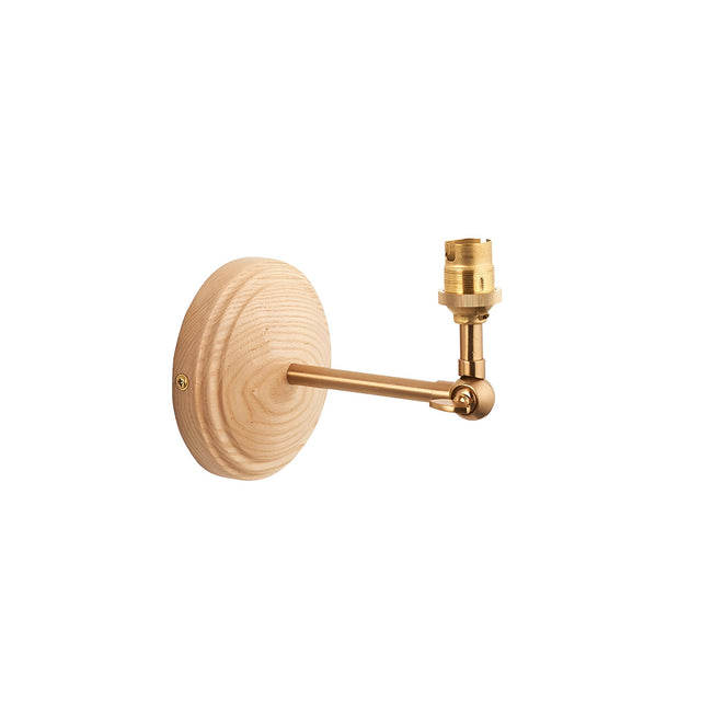 Endon Danemere wall light with round natural ash wood backplate and adjustable brushed aged brass arm ending in a B22 lampholder, on a white background.