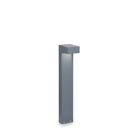 Introducing the Luma Outdoor Bollard Light - Anthracite, 60cm: a sleek, modern lighting fixture with a minimalist design. This outdoor marvel features a rectangular anthracite finish body and an overhanging top that softly emits light, making it perfect for any setting against a plain white background.