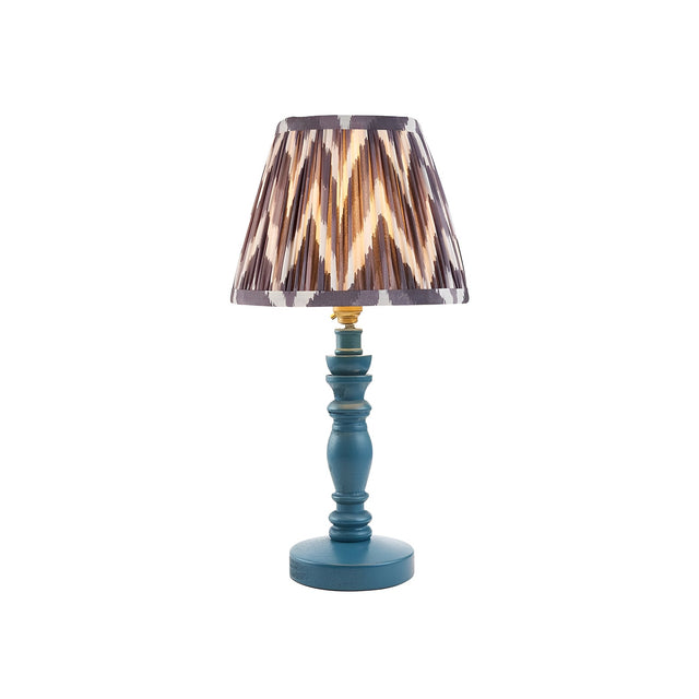 Aldworth Zigzag Table Lamp with turned wooden blue base, brass fittings, and a pleated grey and brown zigzag fabric shade on a plain white background.