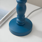 Close-up of the Endon Aldworth Ikat table lamp base, showing the marlin blue satin painted turned wooden spindle on a round foot beside a magazine.