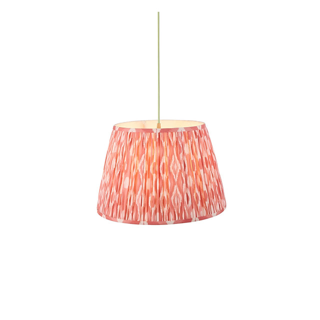 Endon Brackmont pendant light with handmade pleated tapered fabric shade in coral pink Ikat print, brass fitting and green braided cable, on white.