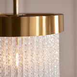 Close-up of the Aldfield Pendant in Brass, featuring a brushed aged brass frame with twisted clear glass rods, lit against a soft neutral background.