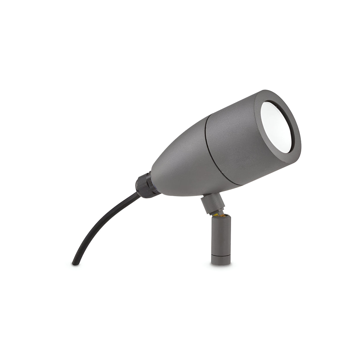 The Radiata Outdoor Single Spotlight in grey features a durable cylindrical design and is mounted on a short stand. It has an IP54 rating, with a black electrical cord attached at the back. The light projects upwards and slightly to the side, set against a white background.