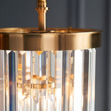 Close-up of the Endon Bevstead pendant showing its brushed aged brass frame and tiered cascade of clear lozenge-shaped glass drops.