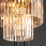 Bevstead 4-light pendant with tiered clear glass lozenge drops in a rounded cascade, set in a brass frame, shown in close-up detail.