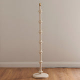 Endon Bevbury floor lamp with a hand-turned white spindle base and brass B22 holder, shown without shade against a neutral wall on wood flooring.