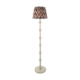 Endon Bevbury floor lamp with turned white spindle base and grey zigzag patterned pleated fabric shade on a plain background.