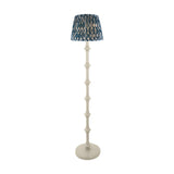 Endon Bevbury floor lamp with white turned spindle wood base and blue Ikat pleated fabric shade, shown on a plain white background.