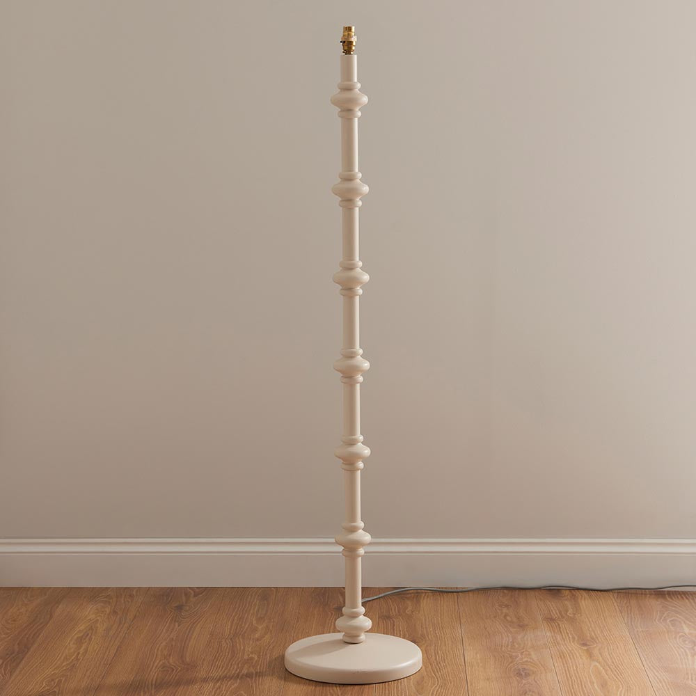 Bevbury Ikat Floor Lamp with white turned wooden spindle base and brass fitting, shown without shade against a plain neutral background.