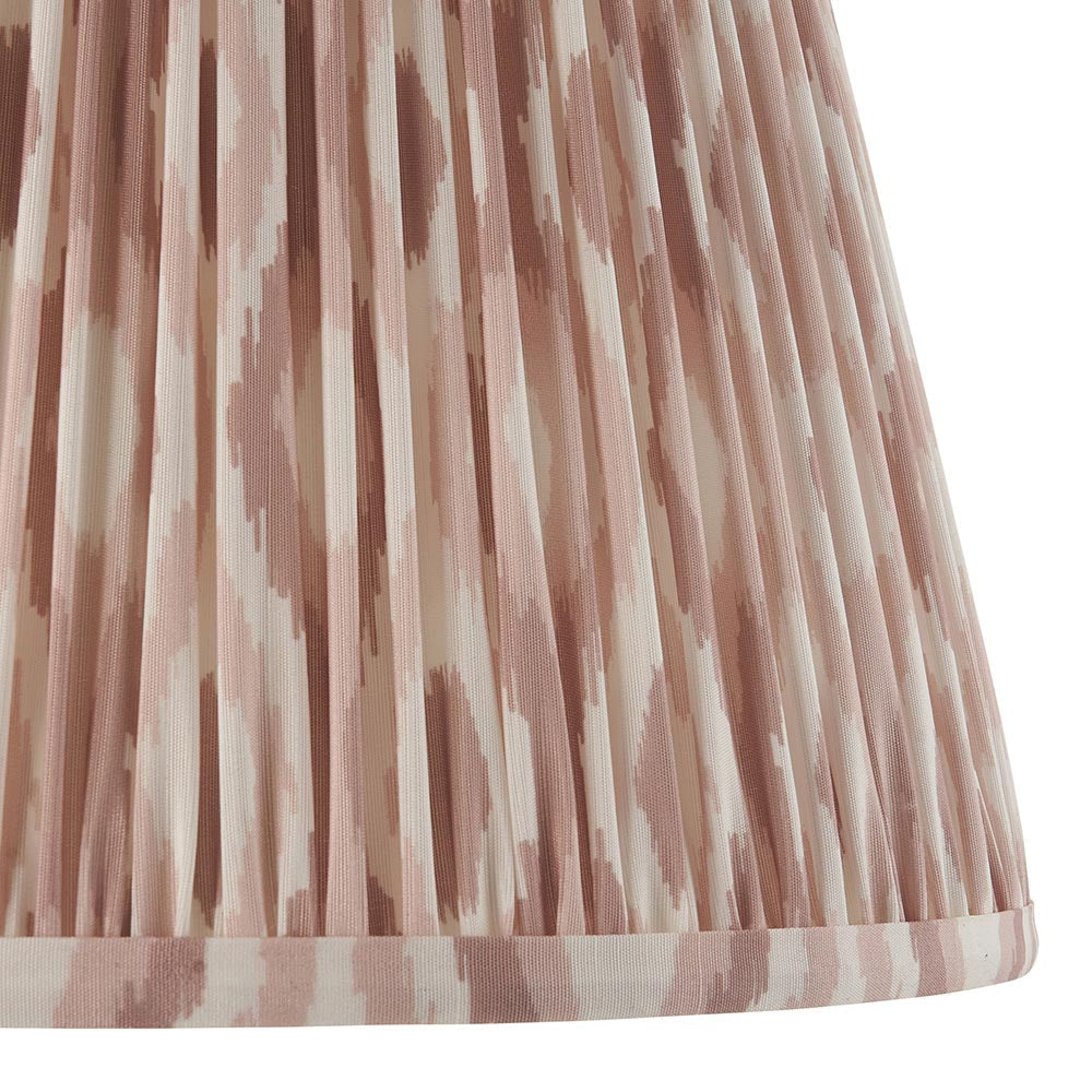 Close-up of the Bevbury Ikat Floor Lamp's pleated fabric shade, showing a patterned faux silk texture in dusty pink and natural tones.