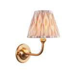 Endon Brackdale Ikat wall light with brushed aged brass curved arm and pleated natural Ikat-print fabric shade, shown on a plain white background.
