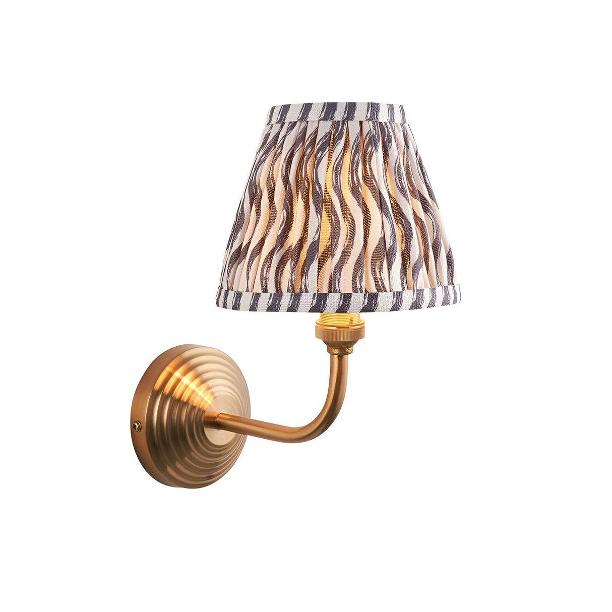 Endon Castgrove Ripple wall light with brushed aged brass stepped backplate, curved arm, and grey rippled pleated fabric tapered shade on white.