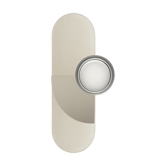 Brera Arco Glass Wall Light in brushed warm steel, with a tall oval beige backplate crossed by a curved metal panel and a round ringed glass shade, shown on a white background.