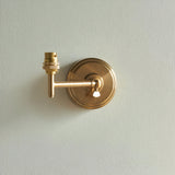 Cliffwood Leaf Wall Light in brushed brass with an adjustable knuckle arm and B22 lamp holder, shown without shade on a plain light grey background.