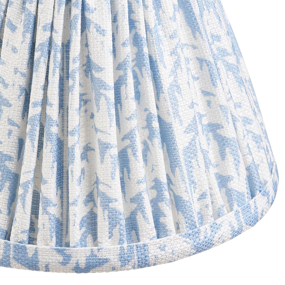 Close-up of the Endon Cliffwood wall light's pleated faux linen shade, digitally printed with a shell bay blue leaf pattern and taped edge detail.