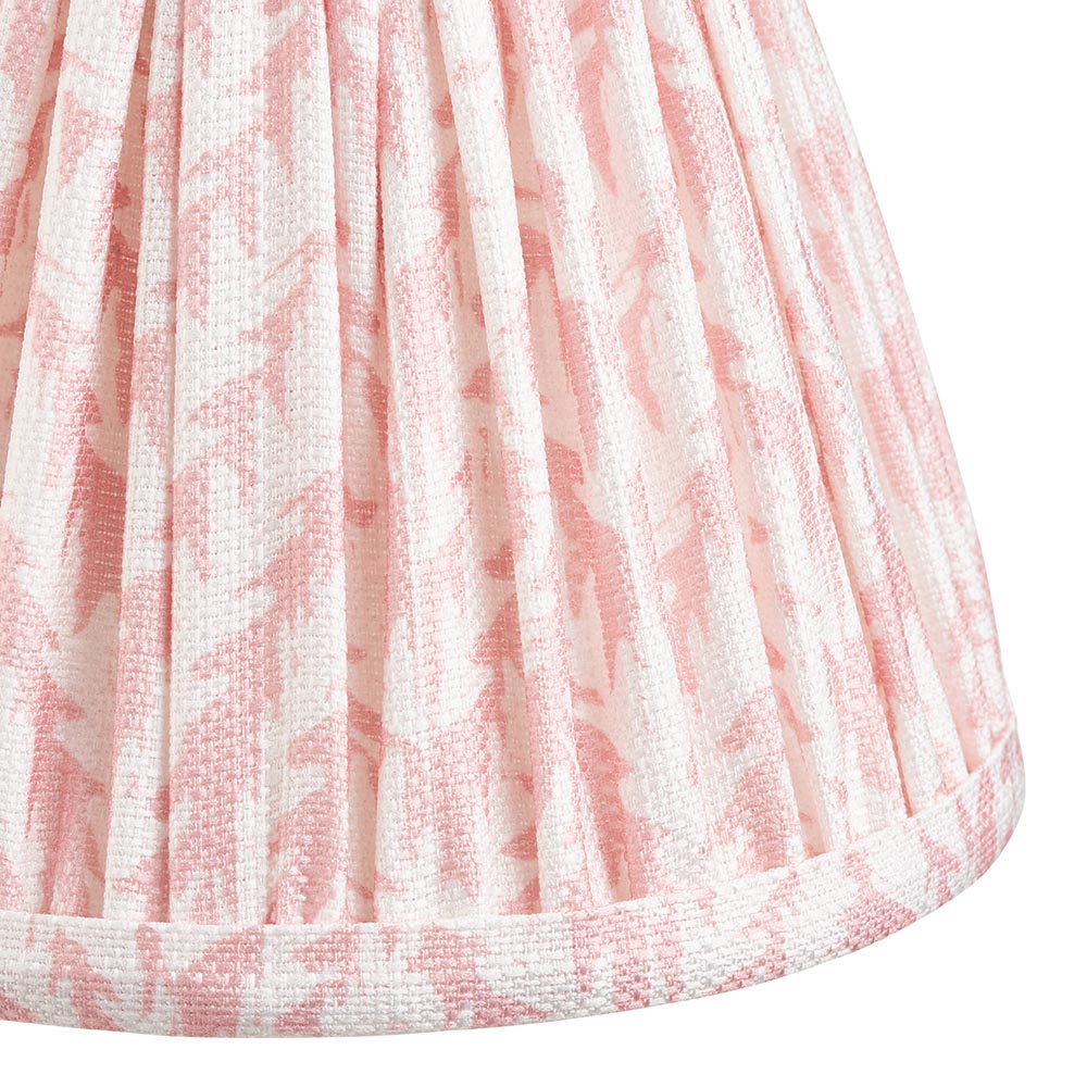 Close-up of the Cliffwood Leaf Wall Light shade in pink and white leaf-patterned fabric with pleated finish and taped edge trim.