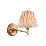 Cliffwood Ikat Wall Light with brushed brass swing arm and pleated fabric shade in an earthy Ikat pattern, shown on a white background.