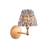 Endon Danemere wall light with natural Ash wood backplate, brushed aged brass adjustable arm and pleated grey leaf-print faux linen shade.