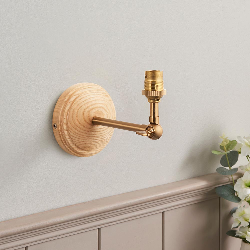 Endon Danemere wall light with round natural Ash wood back plate and brushed aged brass arm with adjustable knuckle and B22 lamp holder, no shade fitted.