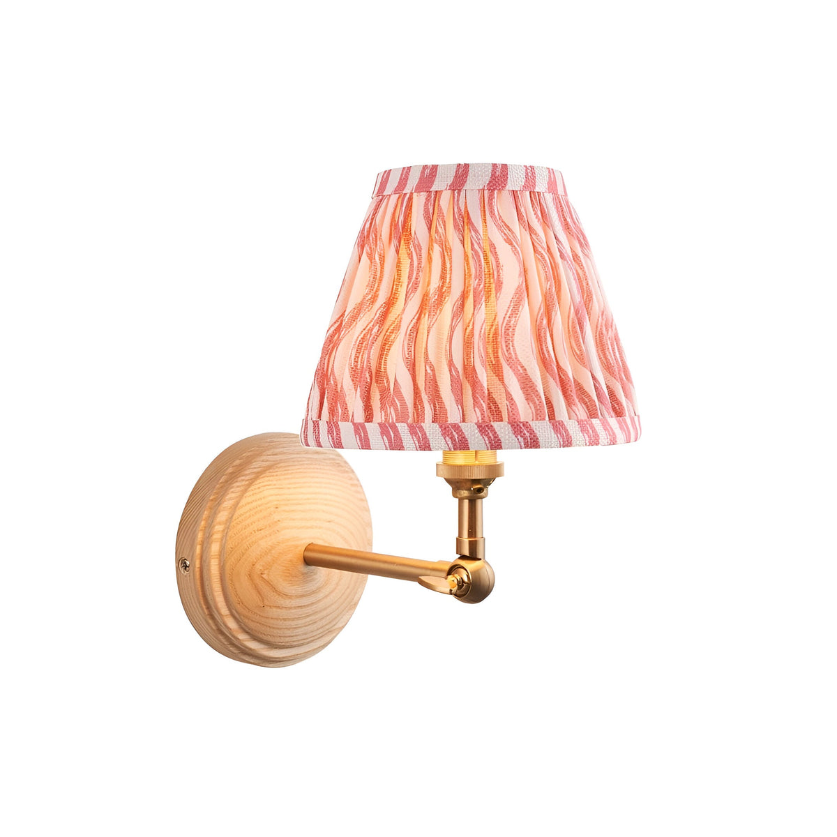 Danemere Ripple Wall Light with ash wood backplate, slim brass arm, adjustable knuckle, and pleated coral pink tapered fabric shade.