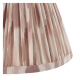 Close-up of the Endon Danemere Ikat wall light's tapered hand-pleated shade in cream faux silk with soft pink brushstroke pattern and taped edge.
