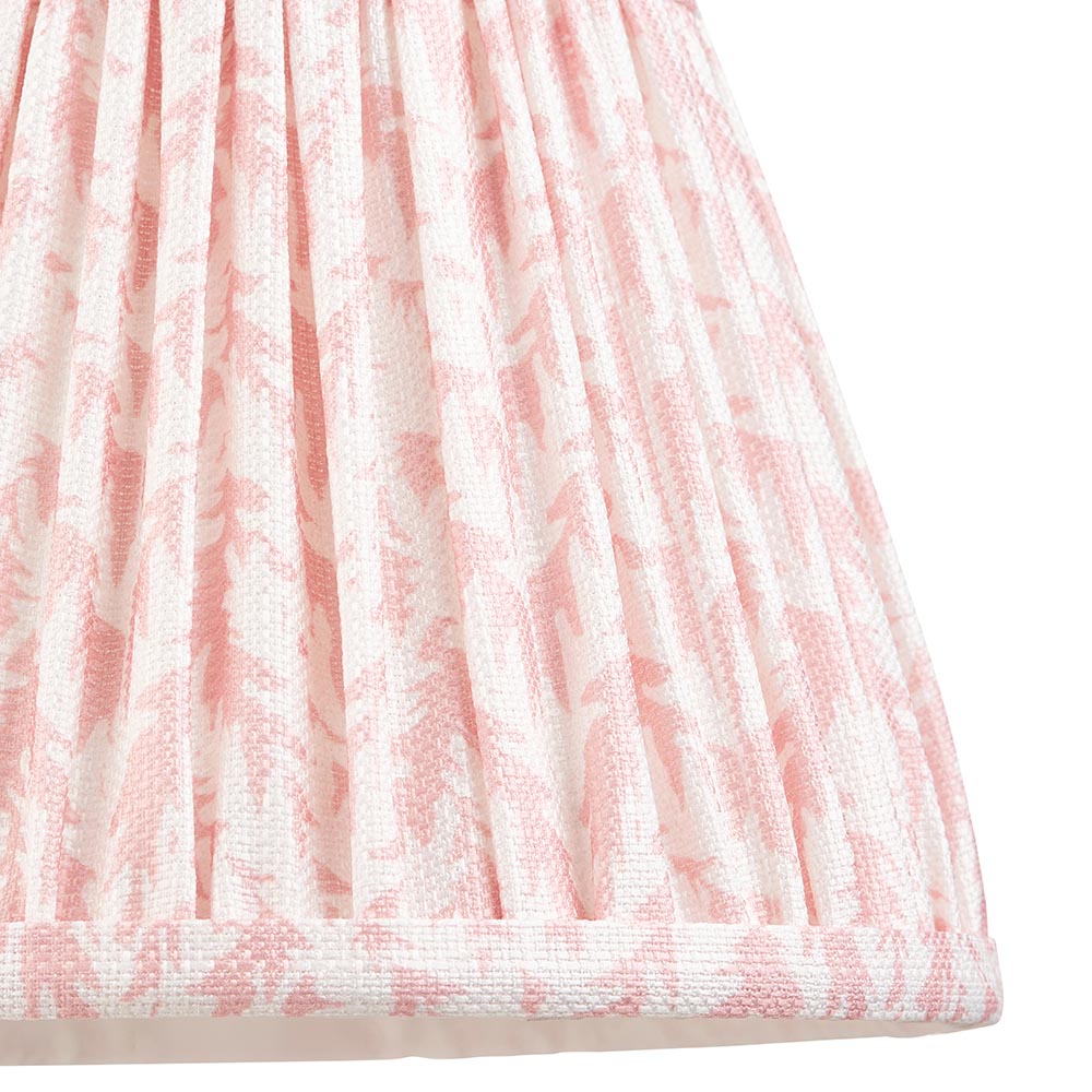 Close-up of the Endon Aldworth Leaf table lamp's gathered and pleated pink leaf-print faux linen shade with taped edge.