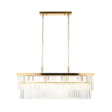 Bevstead 4-light linear pendant in brushed brass with clear glass lozenge drops, suspended from twin adjustable chains on a plain white background.