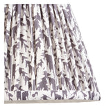 Close-up of the Castleigh Leaf Wall Light's hand-pleated grey and cream patterned fabric shade, showing tapered folds and taped edge trim.