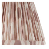 Close-up of the Endon Castleigh Ikat wall light's cream tapered shade, hand-pleated in faux silk with a soft pink Ikat pattern and taped edge.