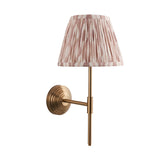 Endon Castleigh Ikat wall light with brushed aged brass stepped back plate, adjustable T-arm and tapered cream and pink pleated ikat fabric shade.