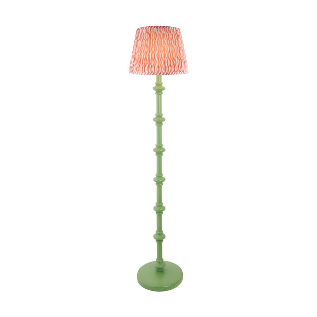 Endon Bevbury Ripple floor lamp with a green turned wooden spindle base and pink rippled faux linen shade, shown on a plain white background.