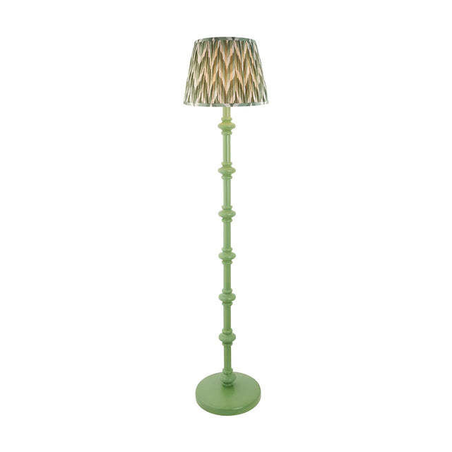 Bevbury turned wood floor lamp in green with a pleated zigzag-patterned shade in grey, brass and green tones, on a plain white background.