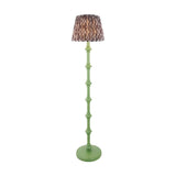 Endon Bevbury floor lamp with green turned wood spindle base and patterned brown Ikat fabric shade on a plain white background.