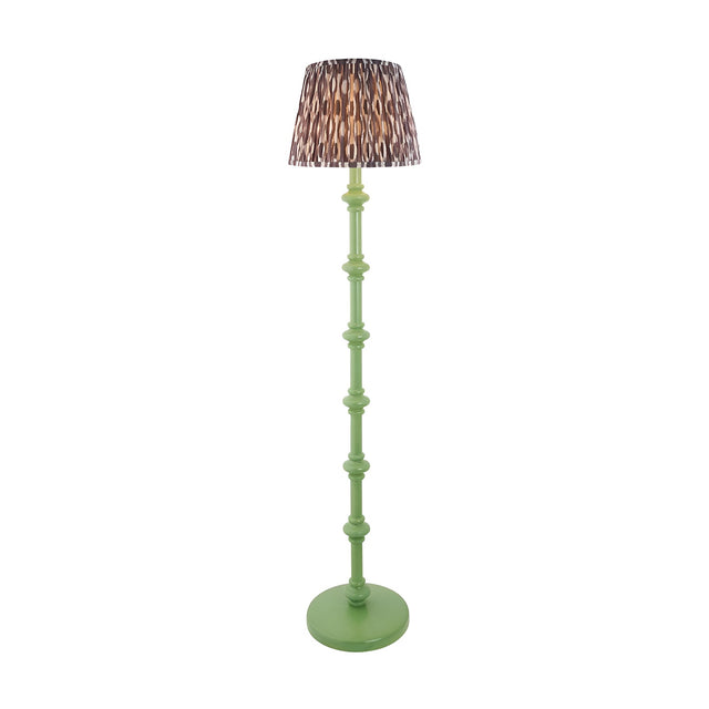 Endon Bevbury floor lamp with green turned wood spindle base and patterned brown Ikat fabric shade on a plain white background.