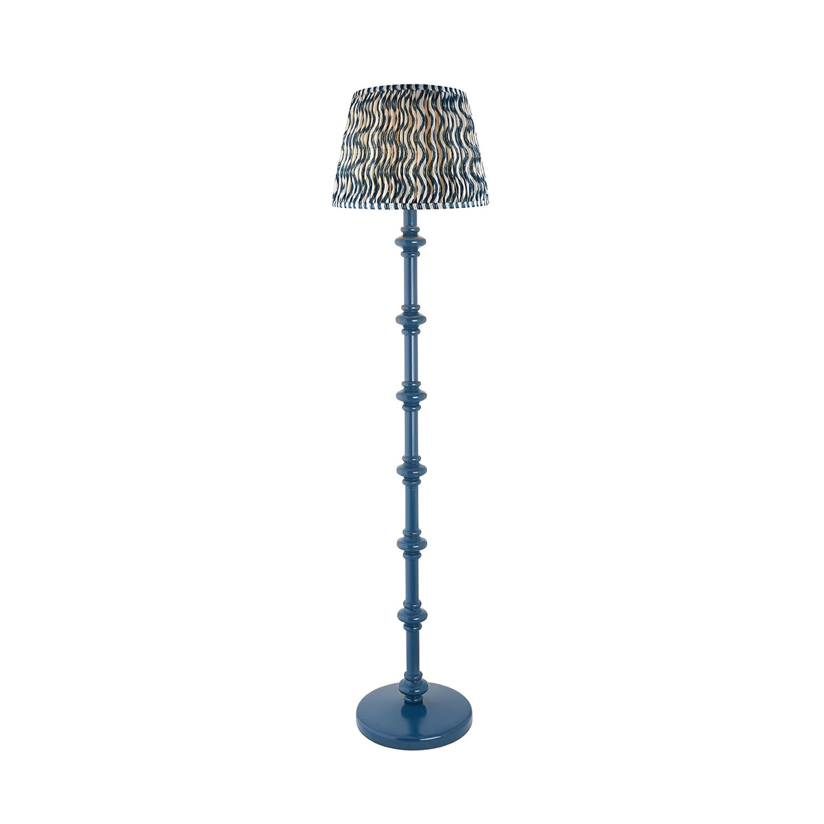 Endon Bevbury Ripple floor lamp with a blue turned wooden spindle base and patterned blue and cream pleated faux linen shade on a white background.