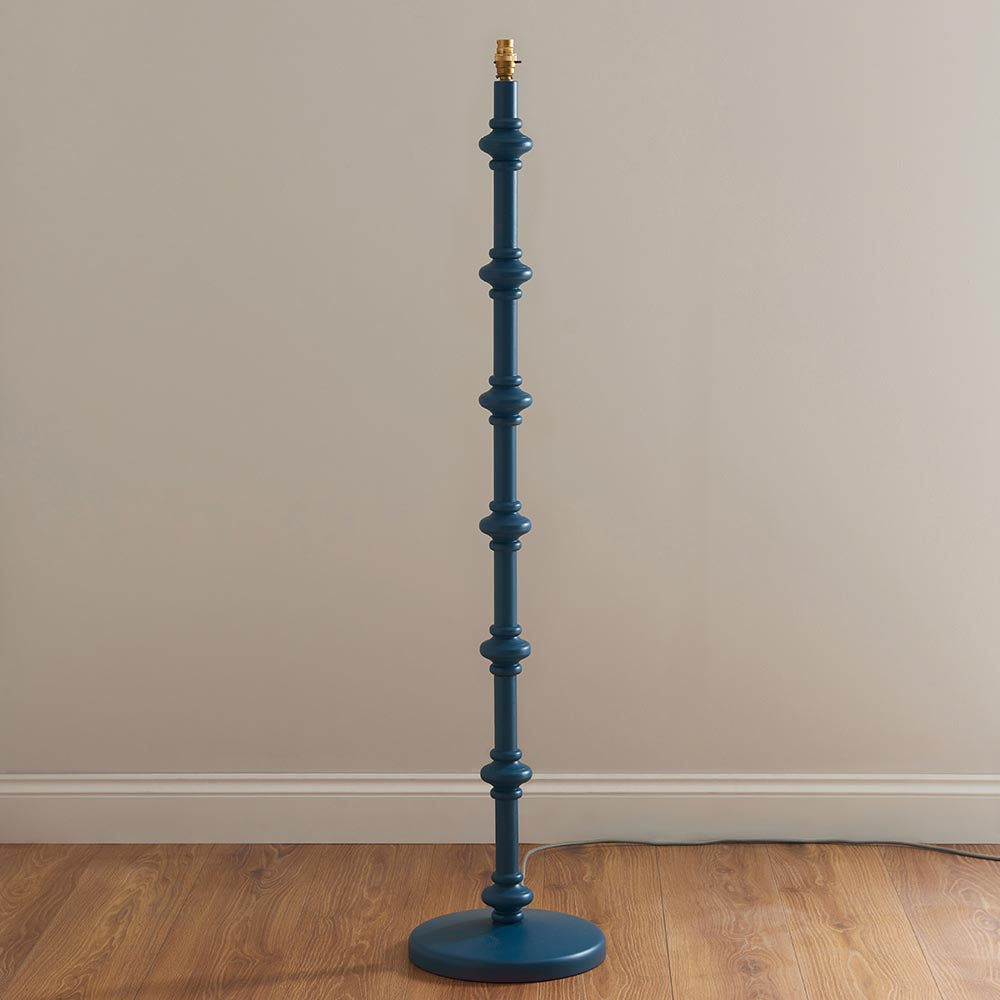Endon Bevbury Ripple turned wooden spindle floor lamp base in marlin blue with brass B22 holder, shown without shade against a plain wall.
