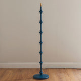 Endon Bevbury Ripple turned wooden spindle floor lamp base in marlin blue with brass B22 holder, shown without shade against a plain wall.