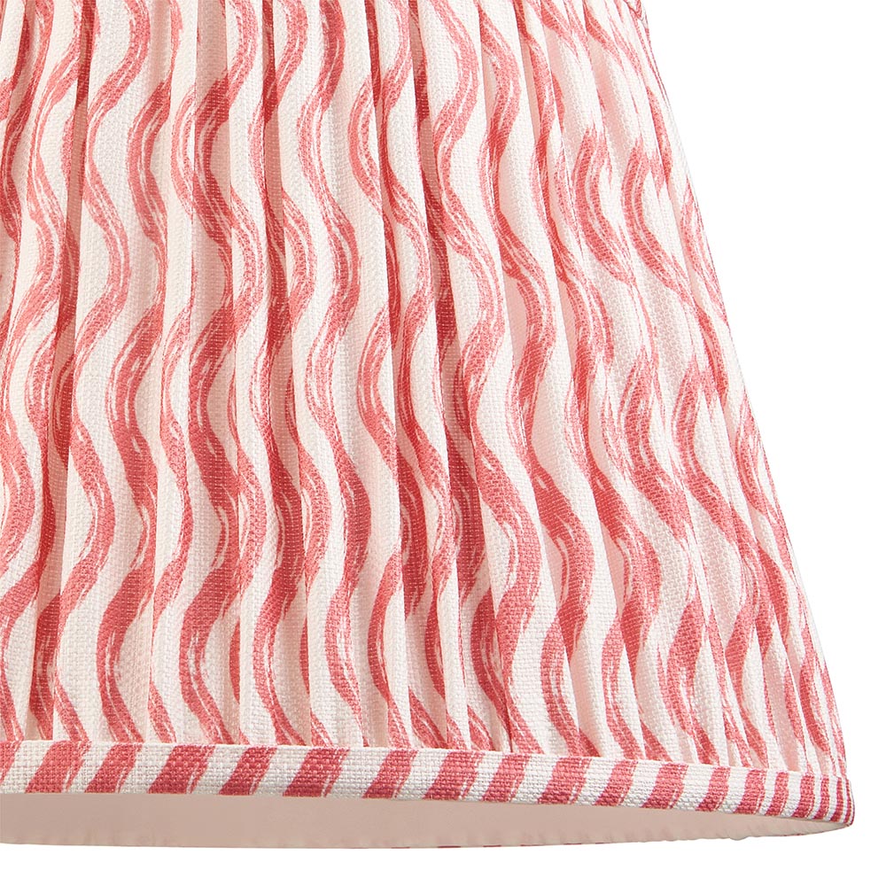 Close-up of the Endon Bevbury Ripple floor lamp shade, showing pink wavy pattern on faux linen with pleated gathers and striped taped edge.
