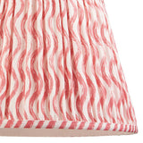 Close-up of the Endon Bevbury Ripple floor lamp shade, showing pink wavy pattern on faux linen with pleated gathers and striped taped edge.