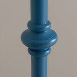 Close-up of the Endon Bevbury floor lamp's hand-turned wooden spindle base in blue satin paint, showing rounded detailing against a neutral background.
