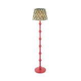 Endon Bevbury Zigzag floor lamp with a pink turned wood spindle base and green zigzag pleated faux silk shade, shown on a plain background.