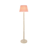 Endon Brenleigh floor lamp with stacked white gloss sphere base and pink Ripple pleated faux linen tapered shade, shown on a plain background.