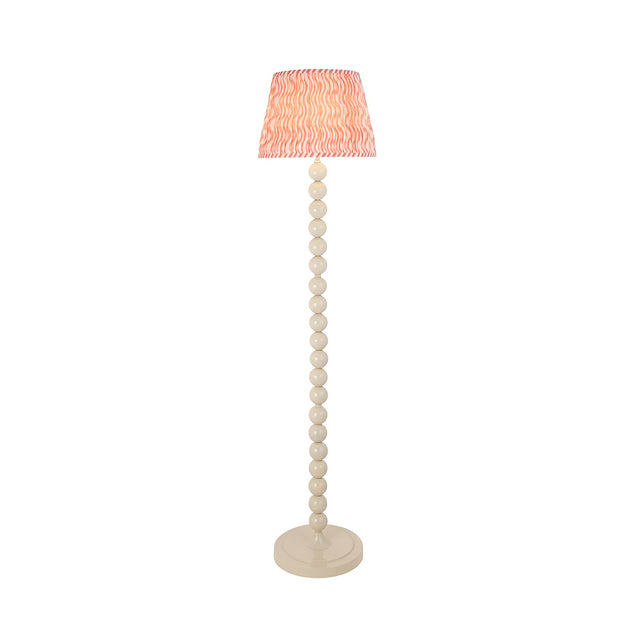 Endon Brenleigh floor lamp with stacked white gloss sphere base and pink Ripple pleated faux linen tapered shade, shown on a plain background.