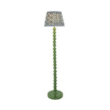 Endon Brenleigh Ripple floor lamp with green stacked sphere metal base and blue and cream ripple-patterned faux linen shade on a white background.