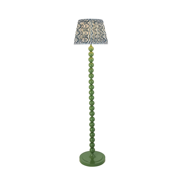 Endon Brenleigh Ripple floor lamp with green stacked sphere metal base and blue and cream ripple-patterned faux linen shade on a white background.
